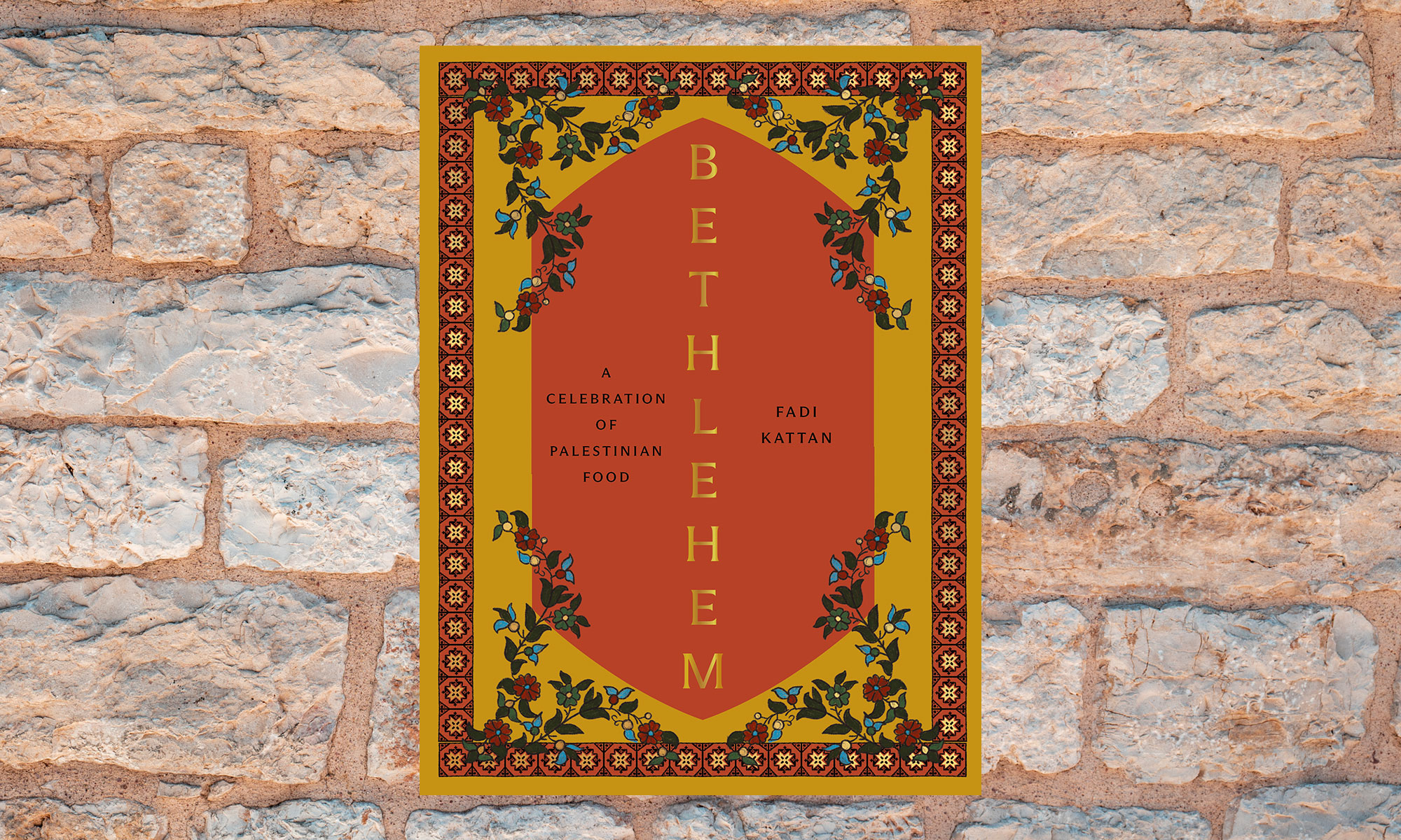 The cookbook cover for “Bethlehem” atop a stone wall