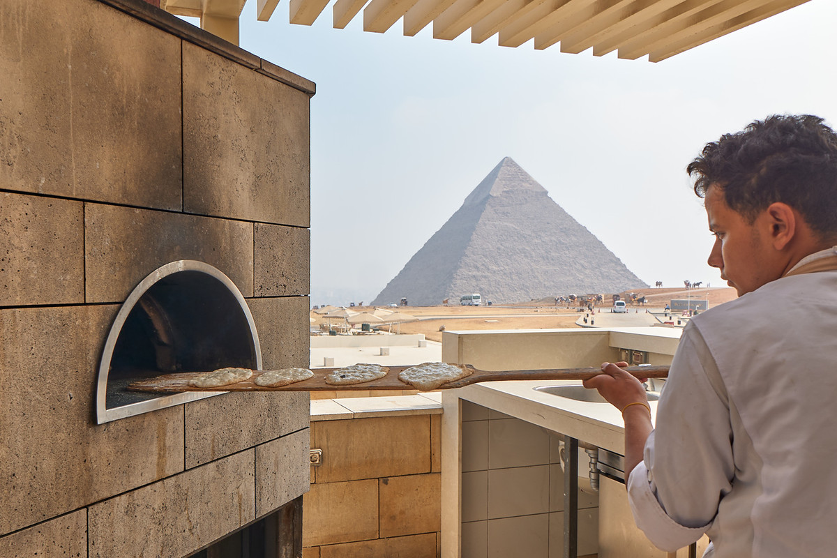 “The bread man” putting bread into an oven via a long plank of wood at Khufu’s in Cairo&nbsp;